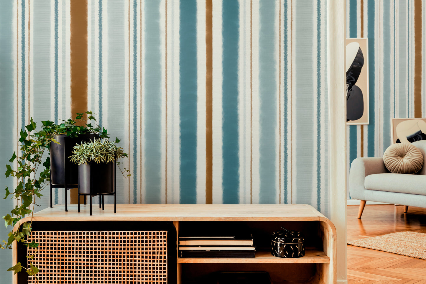 Modern living room with striped wallpaper, a console table, and a sofa.