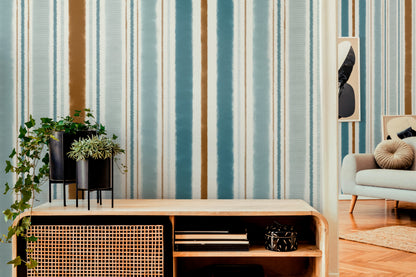 Modern living room with striped wallpaper, a console table, and a sofa.