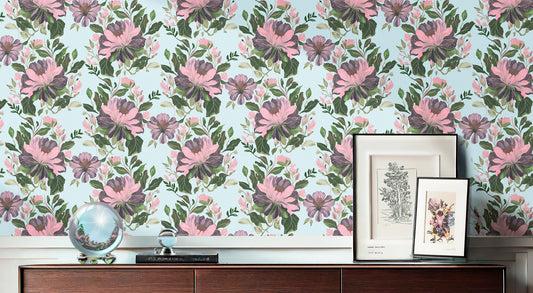 Majestic Dover floral wallpaper featuring large pink and purple peonies with green foliage on a light blue background, styled above a dark wood sideboard.